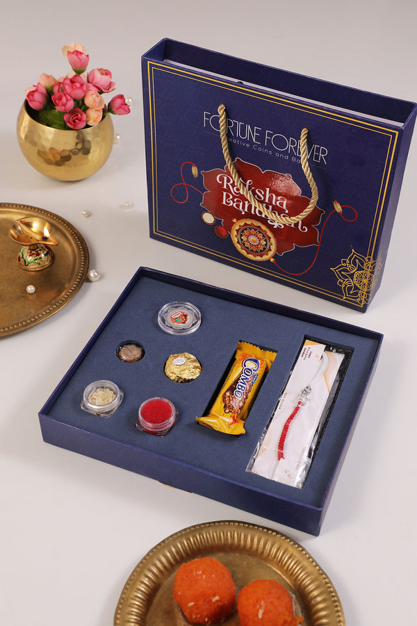 Raksha Bandhan Gift Hamper | 999 Pure 2 Gram Silver Coin BIS HALLMARKED & Silver Rakhi | Complete Rakhi Combo with Chocolate bar, Kumkum, Rice, Jaggery & Round Chocolate | Premium Rakhi Gift Set for Brother/Sister